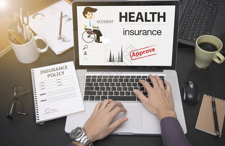 使用计算机和有保护健康保险单页的进行商业务概念事故预防覆盖单背景图片
