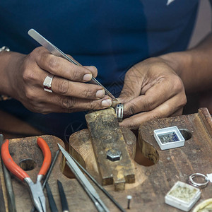 在古董工作台做手工首饰珠宝制作工艺品用紧贴的宝石来修环图片