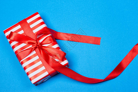 红白包装的礼物蓝色背景带丝图片