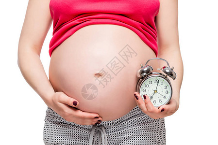 未来婴儿概念照片孕妇用闹钟敲响警钟图片