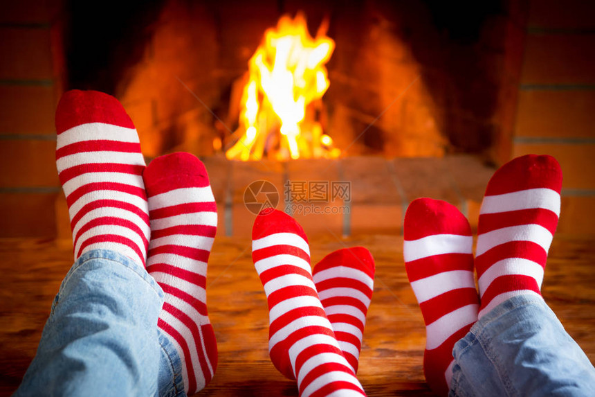 在壁炉附近的温暖的圣诞节袜子里三对图片