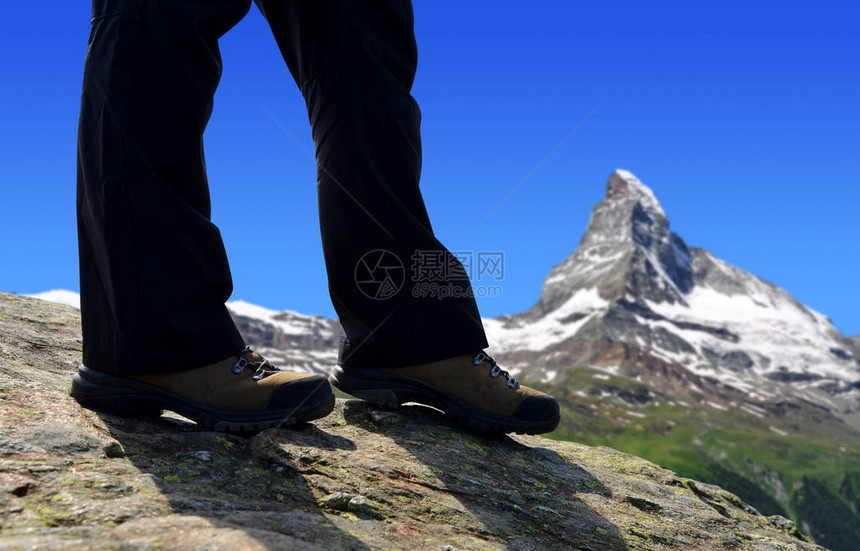 远足者在瑞士马特霍恩山峰的一个背景地区前往潘尼内阿图片