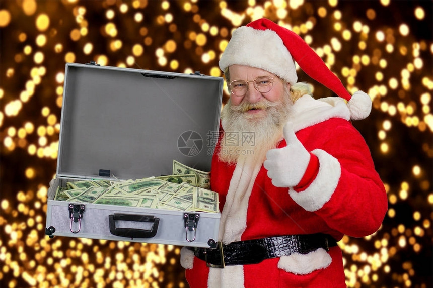 格开朗的圣诞老人带着钱快乐的圣诞老人拿着银外交官用钱和手势竖起大拇指图片