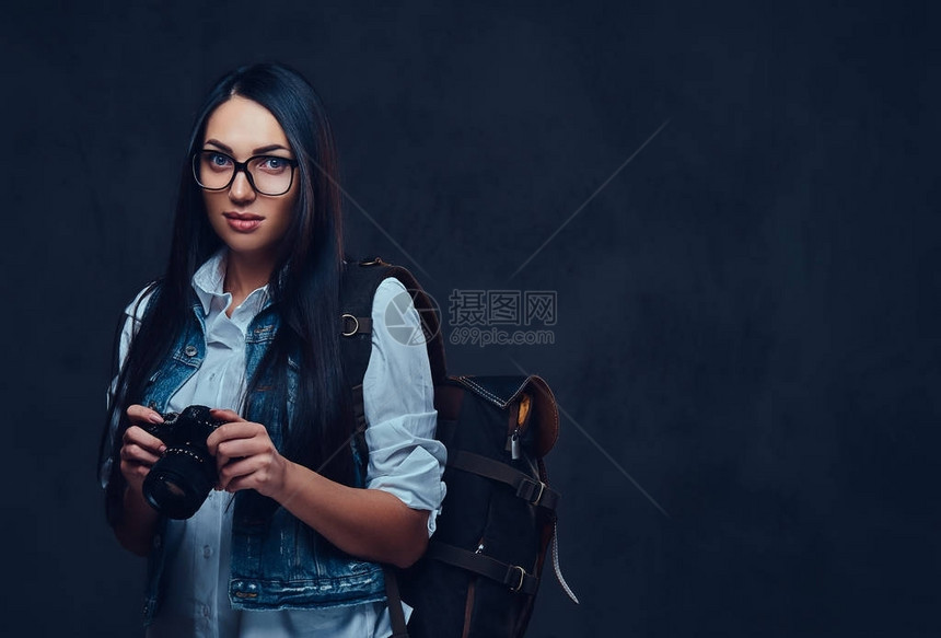 一个带着背包的黑发女旅行者拿图片