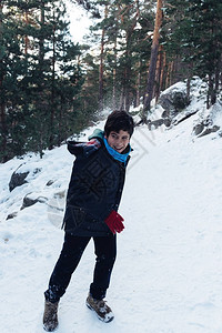 年轻男孩在山上玩雪球玩得图片