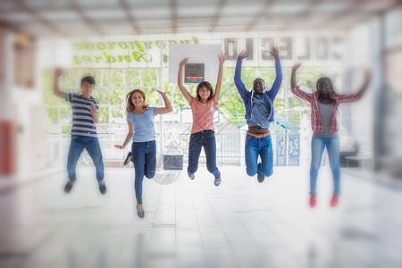 快乐微笑的男女儿童在学校院子里跳跃的国际多种族群体图片