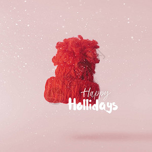圣诞节的概念创造圣诞构想是在粉红色的背景下坠入空气中的红色圣诞帽图片