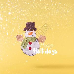 圣诞节的概念创造圣诞节构想由在黄色背景的空中圣诞可爱雪人玩具中落下图片