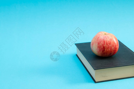 顶蓝底有红苹果的硬封面本教育概念EducationUnive背景图片