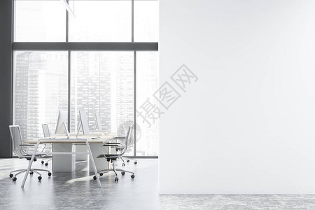 全景开放空间办公室的内部有灰色的墙壁混凝土地板带城市景观的大窗户和一排白色和木制的电脑桌背景图片