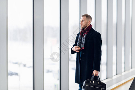 坐在机场候机室等待航班的商人坐在候机区的机场商务休息室里的男主管图片