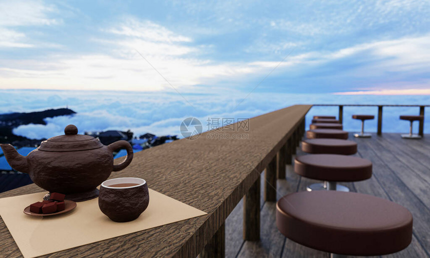 陶瓷茶具和干茶叶放在木头阳台或露台的木桌和椅子上有雾和阳光的早晨海的山上的热茶气氛图片