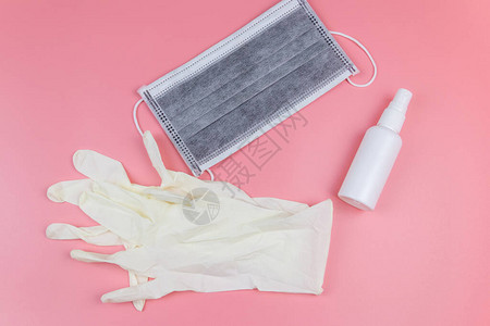 保护一次医疗面罩手套和粉色背景的洗手图片