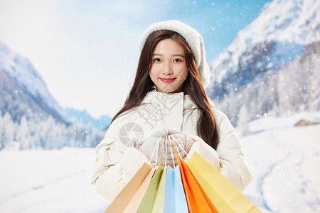 雪地甜美冬季美女手拿购物袋图片