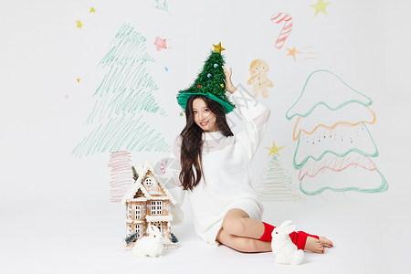 圣诞节素材长冬季美女跪坐在小房子边上背景