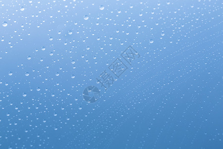挡雨板浸渍滴雨水对玻璃盘的纳米效应Nanoversiegelung浸渍与蓝色背景运行在工作室中创建背景