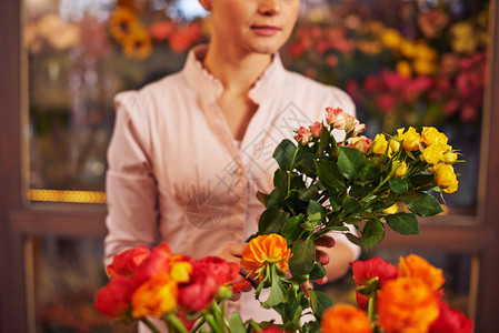 花店里拿着一束鲜花的女人图片