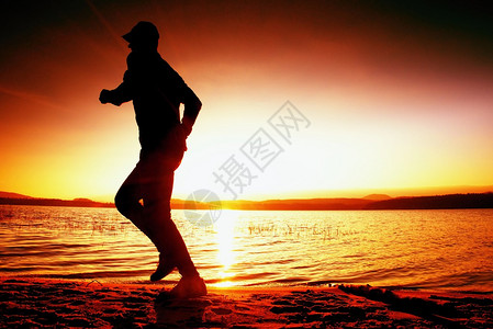 跑在沙滩上奔跑的运动员在沙滩上日出图片