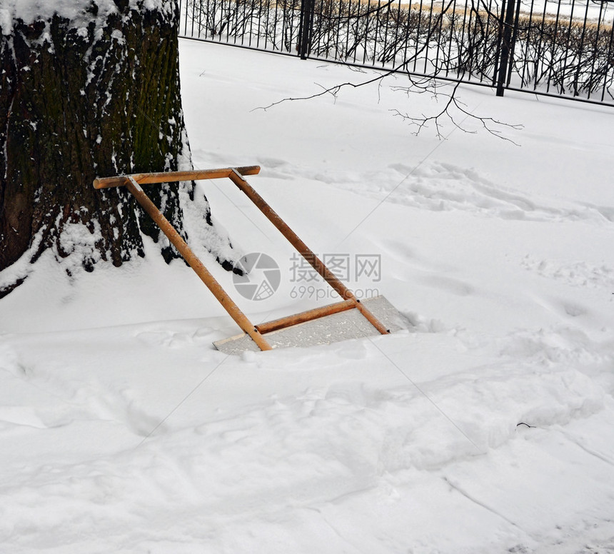 在花园围栏背景下降雪时图片