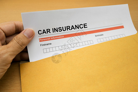 棕色信封上的汽车保险申请表图片