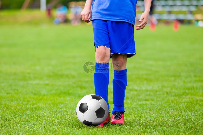 少年男孩踢足球比赛年轻的足球运动员在足球场上图片