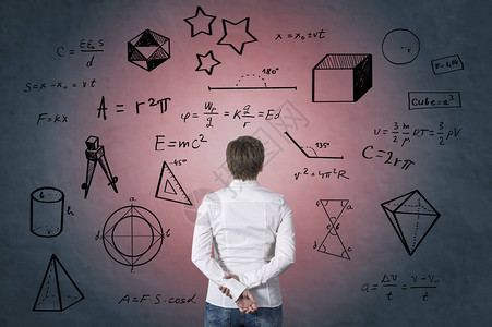 商业人士站在数学公式的前面图片