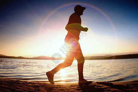 奔跑的人在太阳光芒在海滩图片