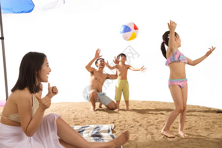 小朋友打排球幸福家庭在沙滩上玩耍背景