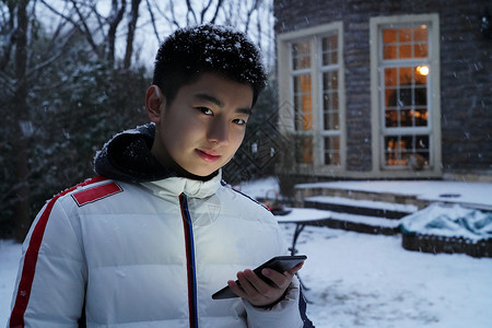 微信雪花素材男孩在院子里玩手机背景