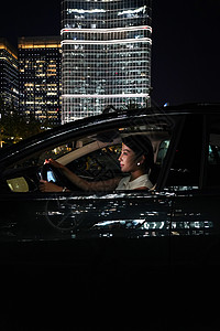 夜晚漂亮的年轻女人驾车图片