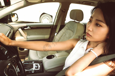 疲惫的青年女人驾车图片