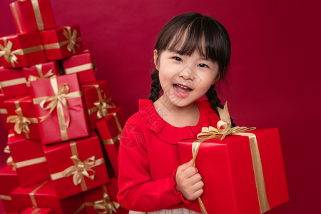 快乐的小女孩收到许多节日礼物高清图片