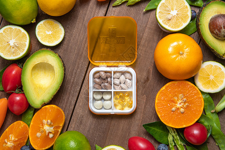 橙色展示展台药盒和绿色果蔬背景