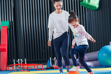 女孩在健身房儿童在教练的指导下进行体能训练背景