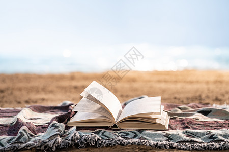 读书海沙滩上的一本书背景