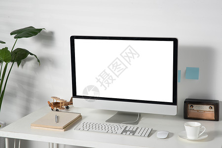 创意杯子盆栽居家办公桌上的电脑背景