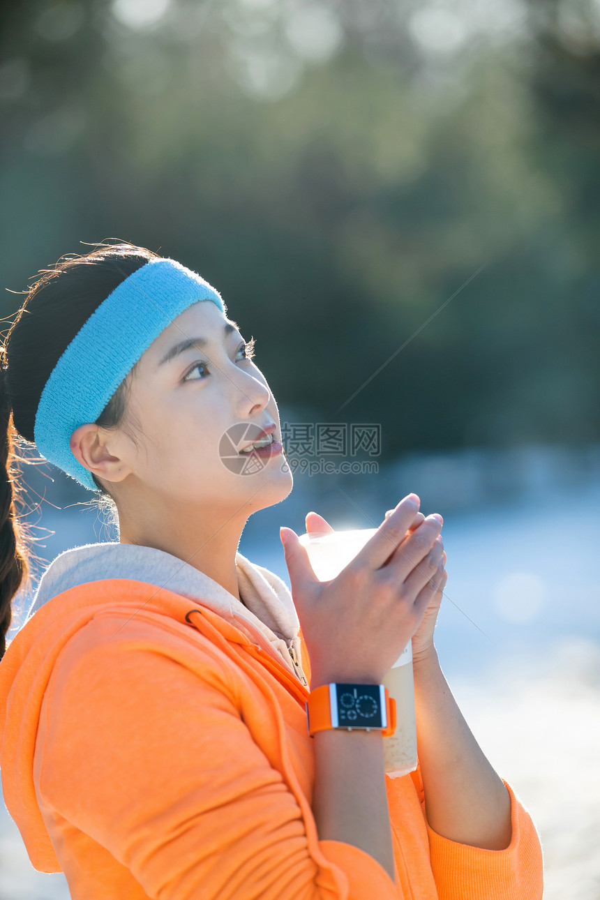 冬季户外的青年女人拿着饮品图片