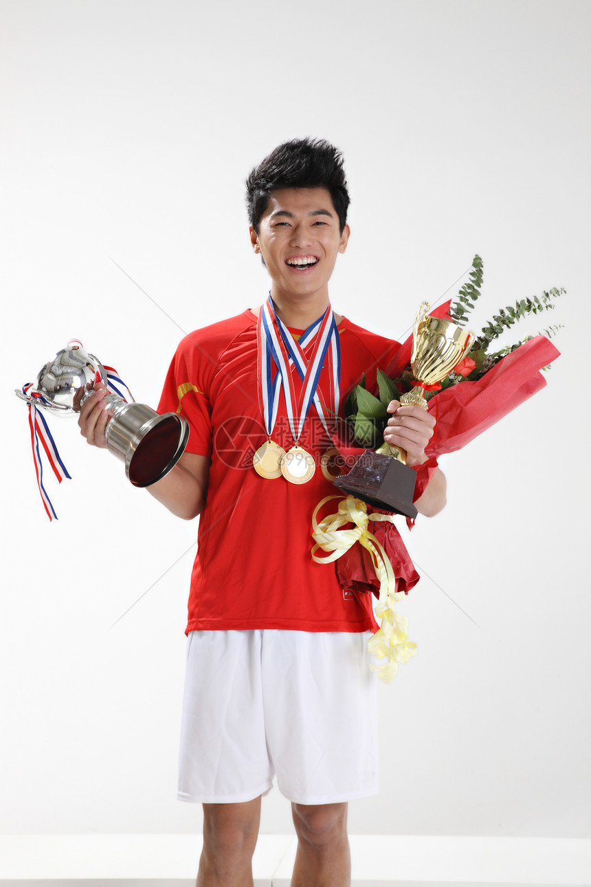 一个东方男运动员手拿奖杯图片