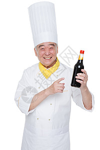 一个厨师拿着调味品背景图片