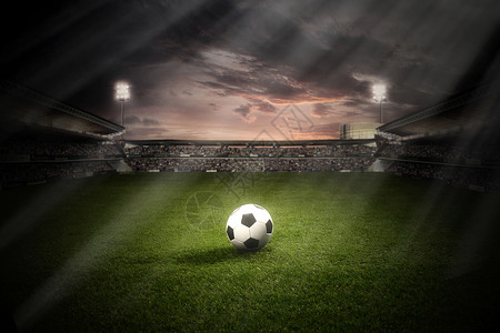 体育场草地上的一个足球背景图片
