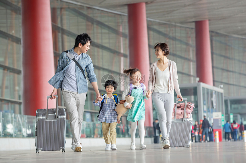 快乐家庭拿着行李在机场图片