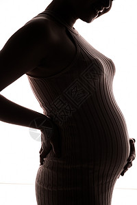 微笑剪影孕妇抚摸肚子背景