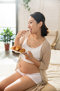 孕妇早餐孕妇正在吃面包背景