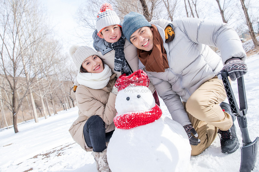 一家三口在雪地里堆雪人图片