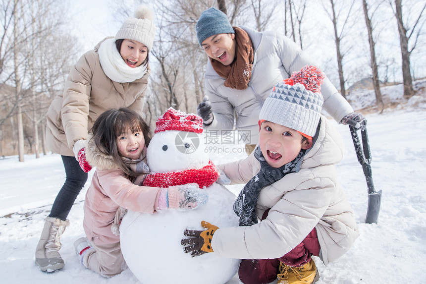 欢乐家庭在雪地里堆雪人图片