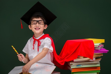 儿童布书戴着学位帽的小学男生背景