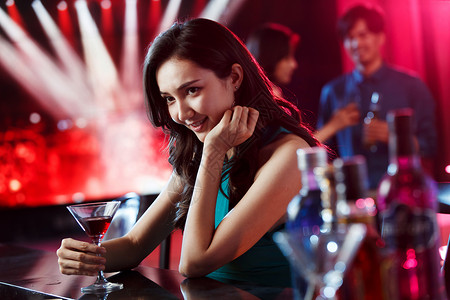青年女人在酒吧喝酒前景聚焦高清图片素材