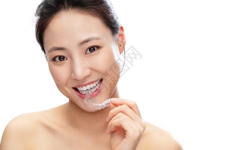 笑脸素材透明拿着咬着透明牙套的青年女人背景