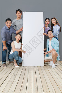 广告素材地板快乐的中青年人扶着白板背景