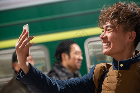 站在火车月台上打电话的旅客高清图片